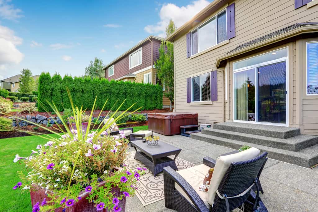 Cozy,Patio,Area,With,Settees,And,Table,,Decorated,With,Flower